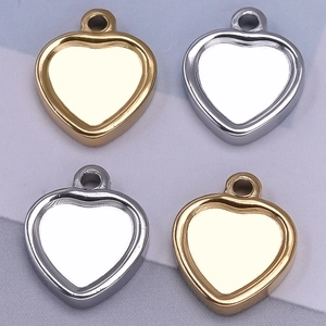 Macro view of gold and silver heart-shaped 304 stainless steel jewelry pendants