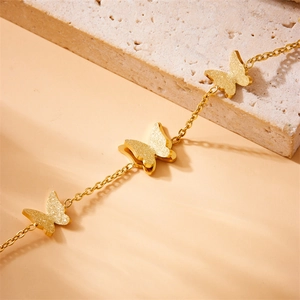 Minimalist gold plated stainless steel butterfly bracelet with frosted texture charms