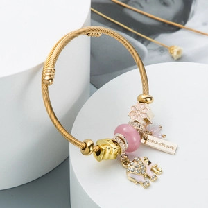 Adjustable twisted gold bracelet with elephant charm and pink cat eye stone beads