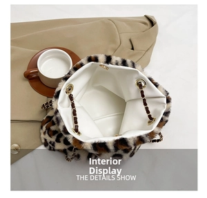 Detailed interior of leopard print faux fur bucket bag with golden eyelets and chain strap
