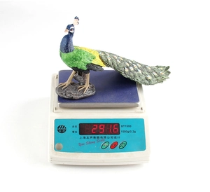 Detailed view of the 291g colorful peacock figurine showing weight on digital scale