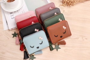 Flat lay of colorful small wallets with tassel and cute cartoon embroidery details