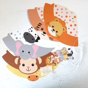 Macro view of DIY animal party hats kit with lion tiger and elephant cardboard cutouts