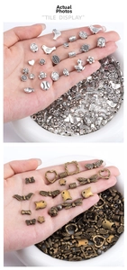 Macro view of vintage bronze and silver DIY alloy pendants in heart and flower shapes