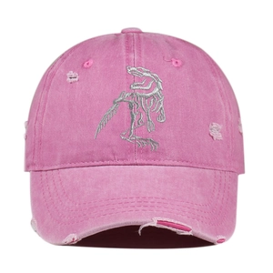 Detailed front view of pink distressed baseball cap with dinosaur skeleton embroidery