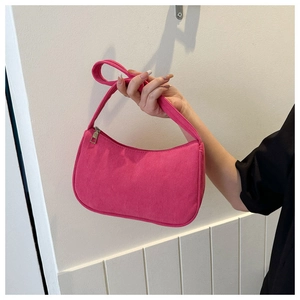 Detailed view of rose red corduroy baguette bag with comfortable shoulder strap handle