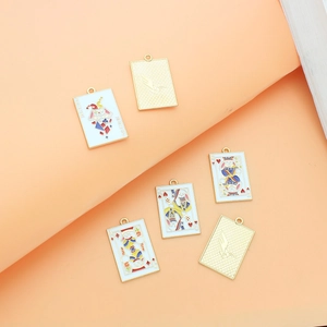Detailed macro view of poker-themed alloy charms with Joker and King enamel designs