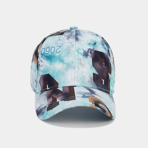 Close-up of blue tie-dye street style baseball cap with S N 2060 graffiti print