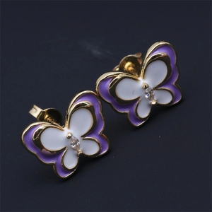 Detail of gold butterfly studs with purple enamel wings and marquise zirconia center