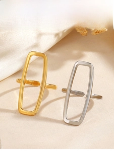 Detail of minimalist 18K gold and silver plated open rectangular rings on silk