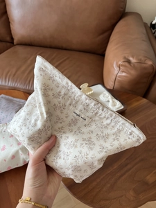 Close-up of small floral cotton makeup bag with Simple Wish label on fabric