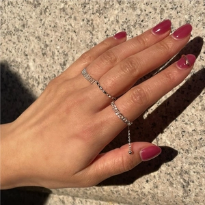 Three-piece sterling silver ring set featuring woven texture, bead chain, and charm detail