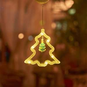 Detail of warm white LED Christmas tree window light with suction cup for holiday decor