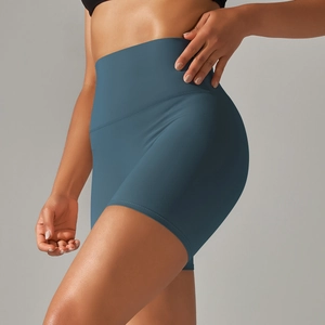 Detail view of high-waisted teal yoga shorts with double-sided brushed elastic fabric