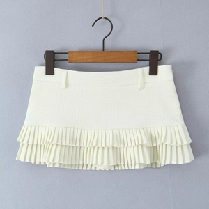 Front view of a white pleated mini skirt featuring high-quality textured woven fabric