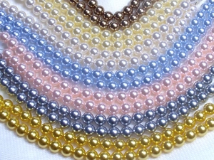 Macro view of multi-colored round craft pearls with glossy finish for DIY jewelry making