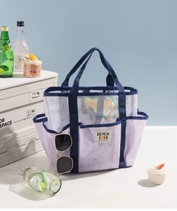Detail of lavender mesh beach bag with multi-pocket design and sturdy handle straps