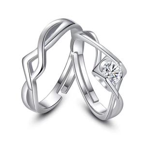 Macro shot of silver couples rings featuring a solitaire stone and Mobius band detail