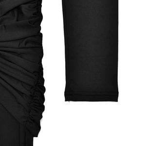 Close-up of black bodycon dress featuring pleated side details and long sleeve texture