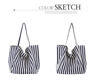 Detailed view of the soft texture and blue vertical stripes on the canvas tote bag