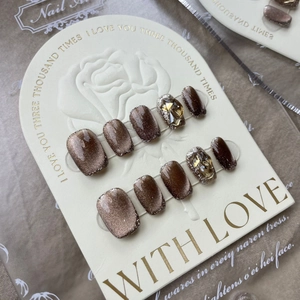 Handmade brown cat-eye press-on nails with silver glitter and amber rhinestones set