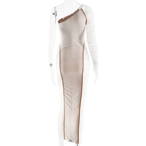 Detail of the asymmetric beige dress showing ruched mesh sleeves and brown piping details