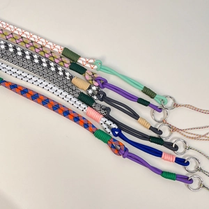 Detail of adjustable woven nylon straps with metal rings for crossbody bags and phone cases