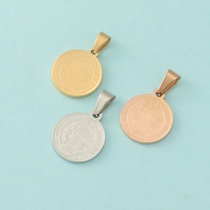 Detailed view of Saint Benedict pendants in gold, silver, and rose gold stainless steel