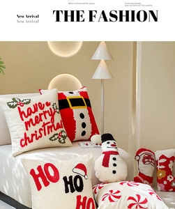 Detailed view of tufted Christmas pillows featuring Santa and snowman shapes on a sofa