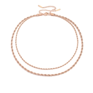 Close-up of double-layered rose gold rope chain necklace with lobster clasp and extender