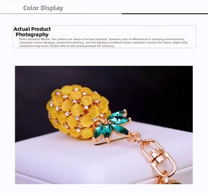 Macro detail of pineapple keychain with yellow opal beads and green crystal leaves