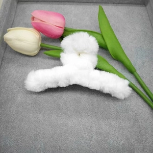 Fluffy white 11cm plush shark hair claw clip displayed with floral tulip accents