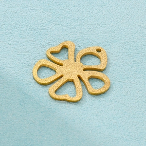 Macro detail of a matte gold-plated five-petal flower pendant with frosted texture