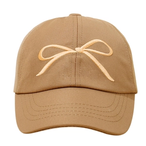 Detailed view of the elegant bow embroidery on a classic brown sunshade baseball cap