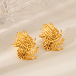 Golden stainless steel swirl stud earrings with a radial fireworks texture on beige background