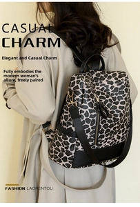 Detail view of leopard print backpack with high-quality gold hardware and anti-theft back pocket