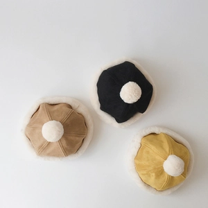 Three colors of faux suede winter hats with plush lining and fluffy pompom details