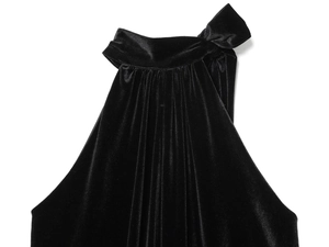 Detailed close-up of a black velvet halter top featuring a delicate bow tie and soft pleats