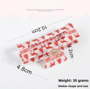 Detail of Christmas claw clip with red elk pattern and 10.2cm size specification