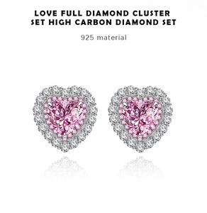 Macro shot of 925 silver stud earrings with heart-cut pink diamonds and zircon pavé