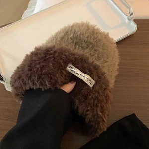 Close-up of contrast faux fur knit hat texture with brand label and plush finish
