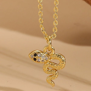 Detailed view of a 14K gold plated snake pendant necklace with shimmering zircon stones