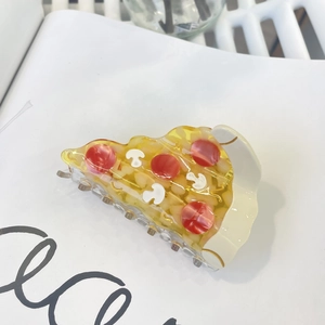 Close-up of cute pizza slice hair claw clip with colorful resin toppings and cheese details