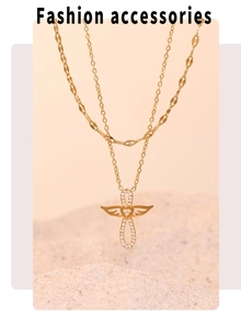 Gros plan du collier double épaisseur doré avec pendentif croix ailée et incrustation de zircon