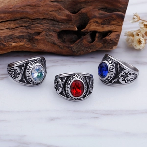 Detailed close-up of military style stainless steel rings with red and blue gemstones