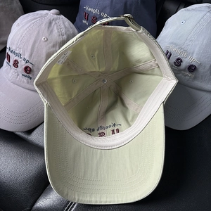 Set of four embroidered cotton baseball caps in yellow, grey, navy and blue colors