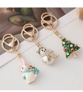 Detail of Christmas tree and snowman keychains with enamel oil and sparkling rhinestones