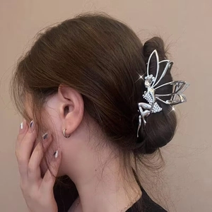 Silver metal fairy butterfly hair claw clip with rhinestones worn on a bun hairstyle