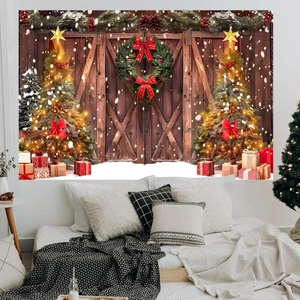Christmas backdrop featuring a festive garland door with trees and gifts in a bedroom