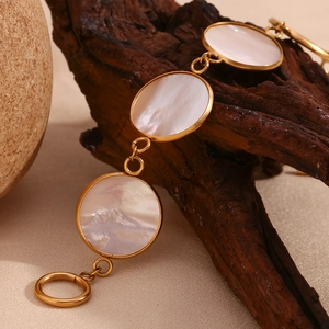 Close-up of 18K gold-plated OT buckle bracelet with circular mother of pearl inlays